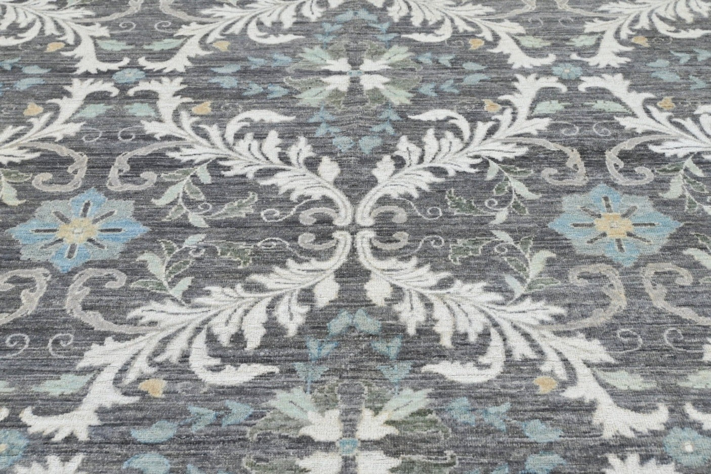 Knotted rug handknotted wool classic look. Quiet luxury in shades of gray, charcoal, blue, taupe, and ivory.
