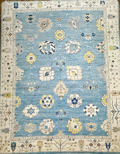 Classic Oushak hand-knotted rug. Crisp blue background with accents of navy, buttercup, sage, and ivory. Exact size 12'2" x 15'2". Fine quality luxury rug.