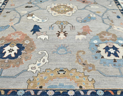 Luxury wool 9 x 12 oushak rug with navy, blue, gold, and gray.