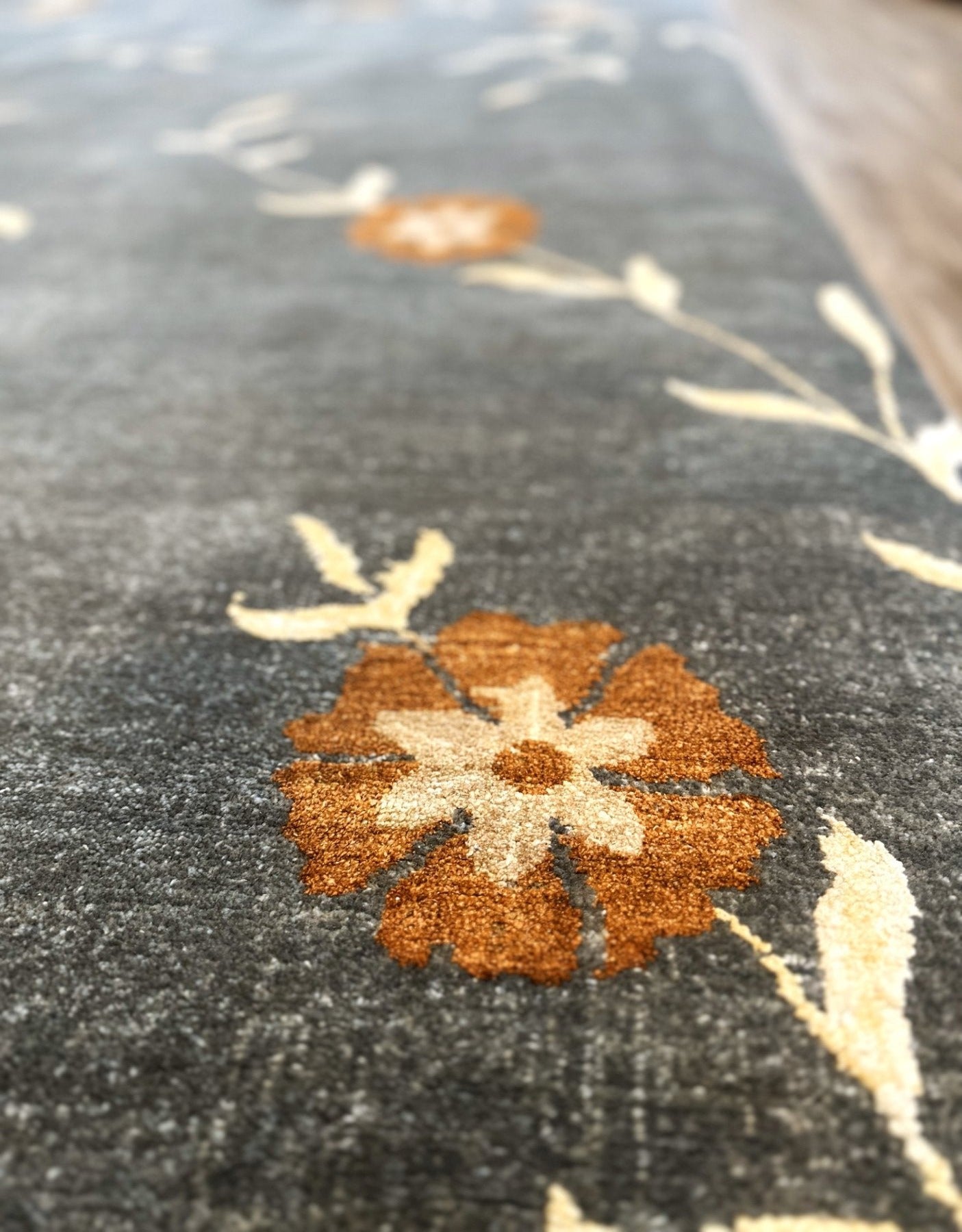 Hand Knotted wool and silk rug with a floral pattern. Gray, persimmon, cream modern hand knotted rug.