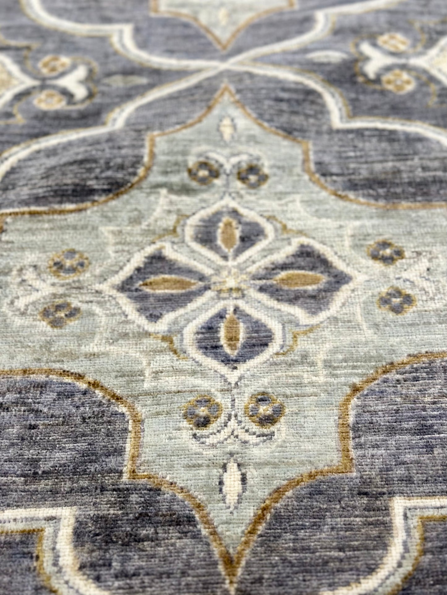New traditional gray hand-knotted rug with large scale, repetitive pattern with accents of seafoam, brass, and tobacco brown. Size 5 x 7
