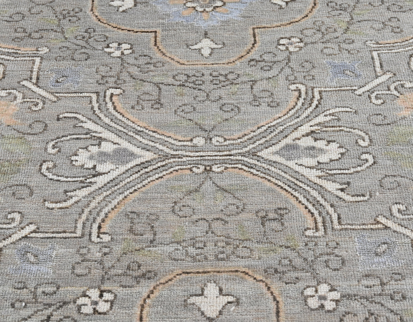 Hand-knotted wool ten foot long runner with a transitional pattern in gray, blue, cream, and tan
