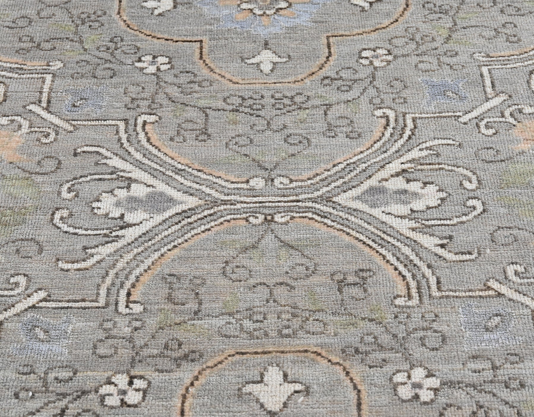 Hand-knotted wool ten foot long runner with a transitional pattern in gray, blue, cream, and tan