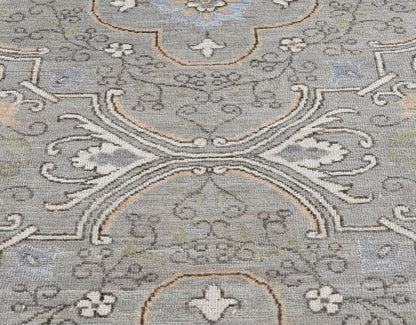 Hand-knotted wool ten foot long runner with a transitional pattern in gray, blue, cream, and tan