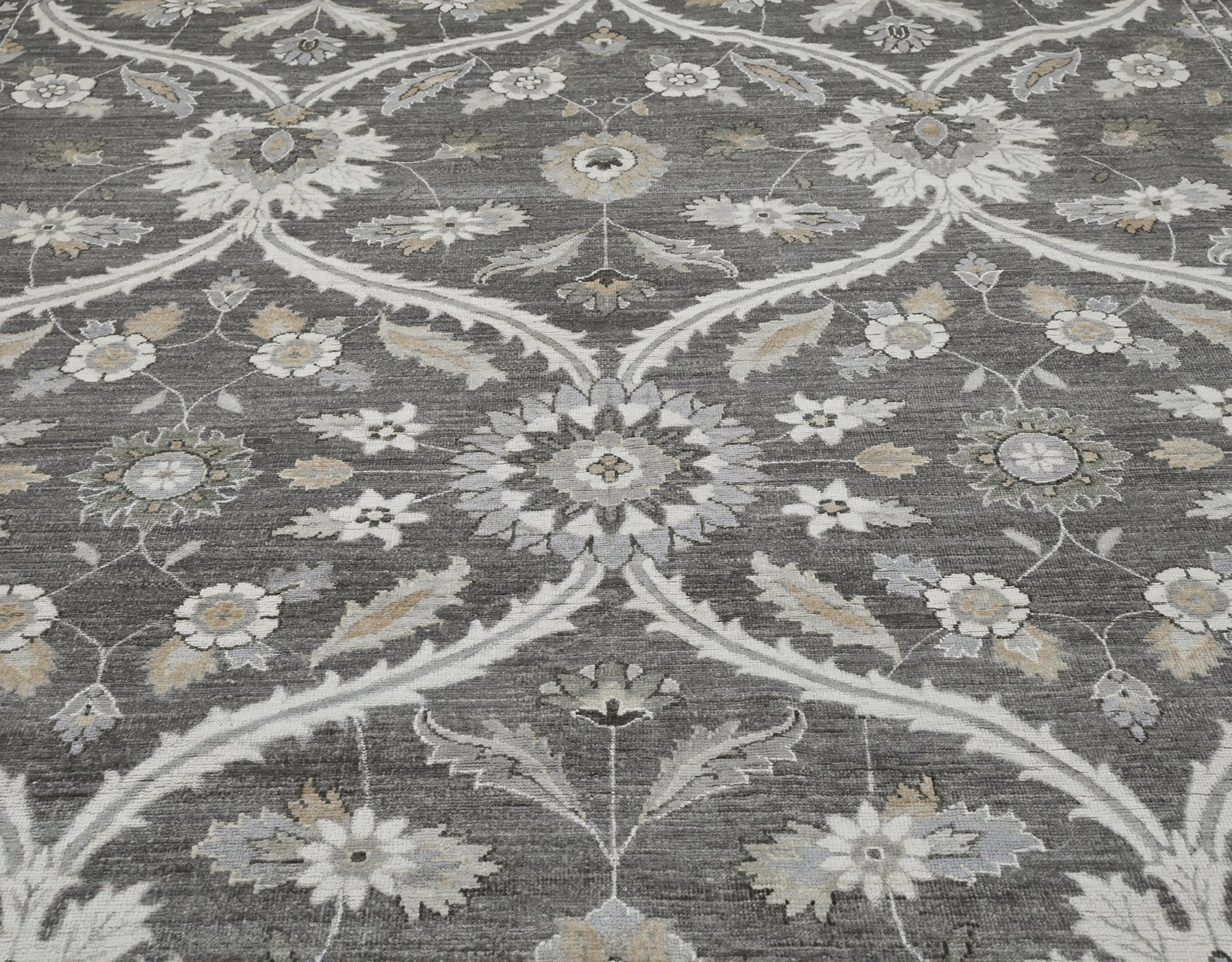 Luxury handknotted 8 x10 woolrug. Gray overall color with accents of ivory, beige, and camel. Soft flowing pattern with a border.