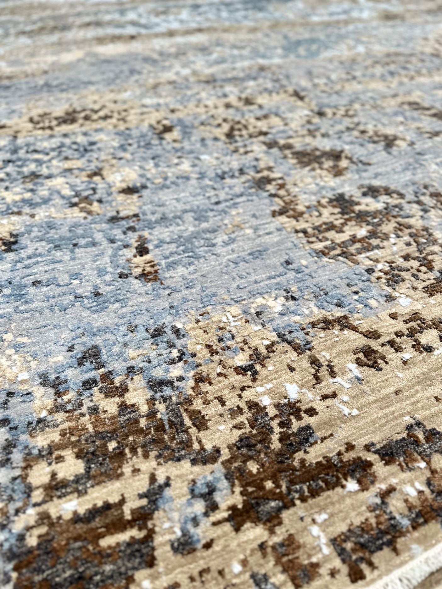 Couture Rug. Luxury hand-knotted rug with an abstract pattern in blue, brown, green, and cream.