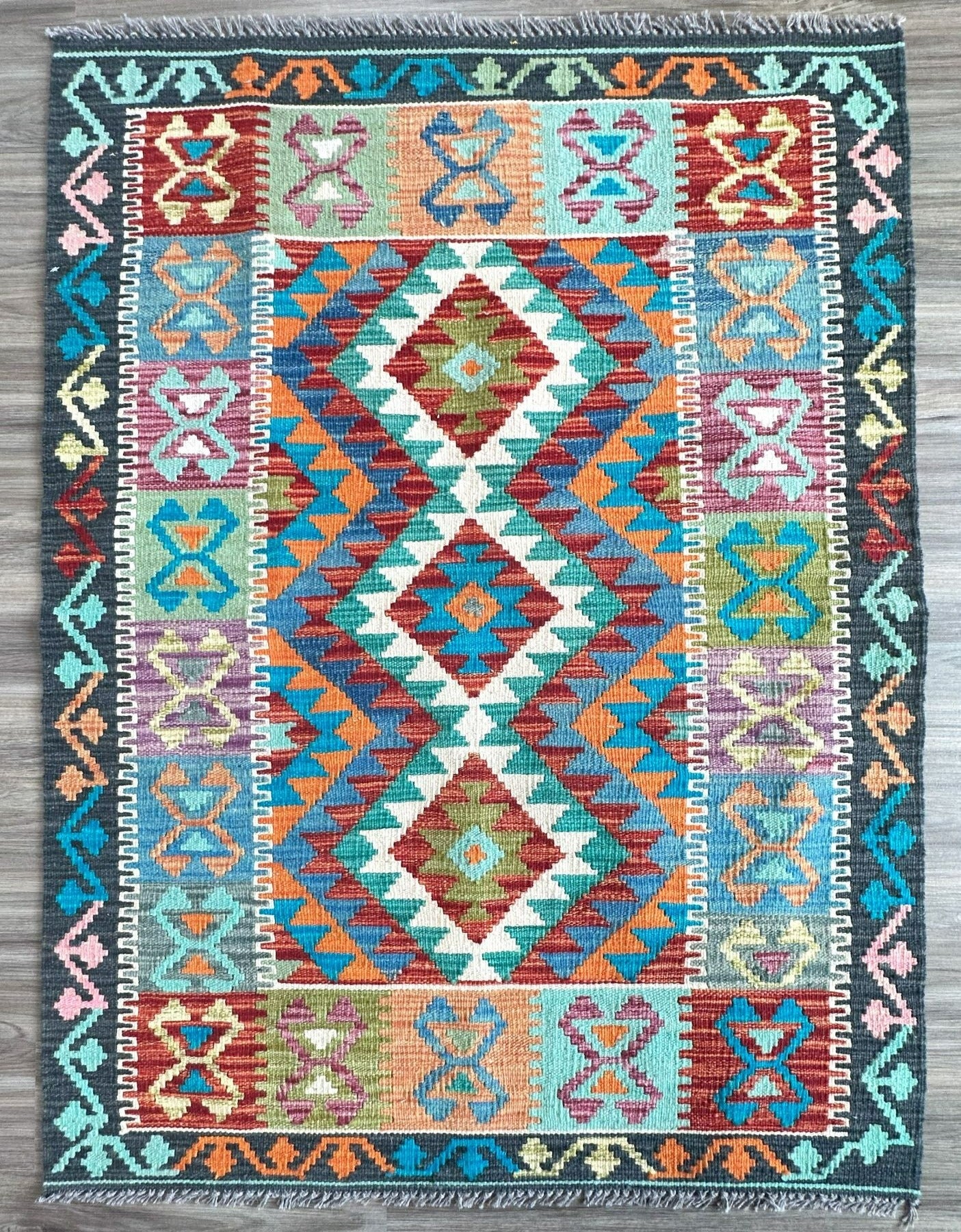 Affordable handknotted rug with geometric pattern. Best flatweave kilim rug with multiple colors of gray, red, yellow, & turquoise.