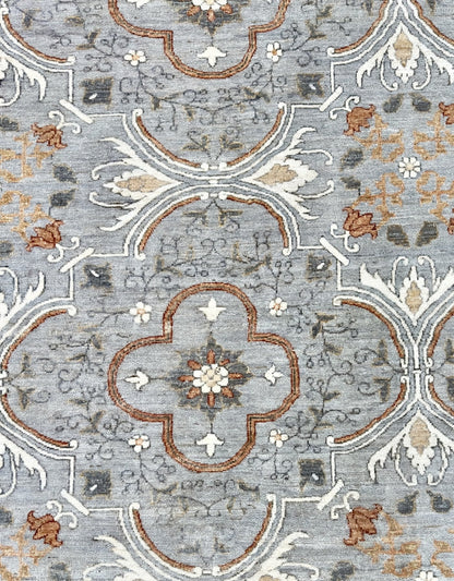 Knotted Couture hand knotted luxury rug in shades of gray, cream, and paprika