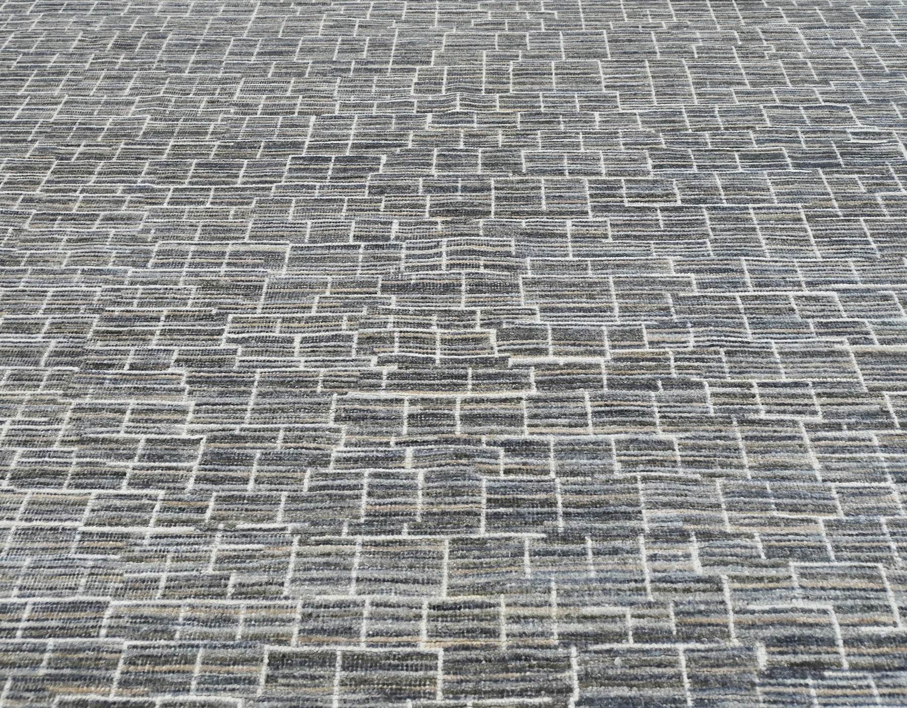 Luxury modern hand-knotted gray rug with an abstract, linear pattern in neutral shades of gray, cream, & ivory.