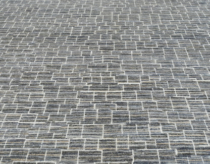 Luxury modern hand-knotted gray rug with an abstract, linear pattern in neutral shades of gray, cream, & ivory.