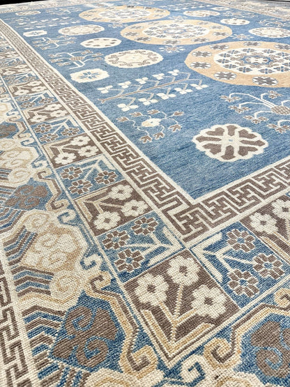 Stunning luxury hand-knotted rug! Reminiscent of a ming vase, with a greek key border band. Blue field with accent colors of brown, cream, and cafe au lait. Large rug measuring 12' x15'6".