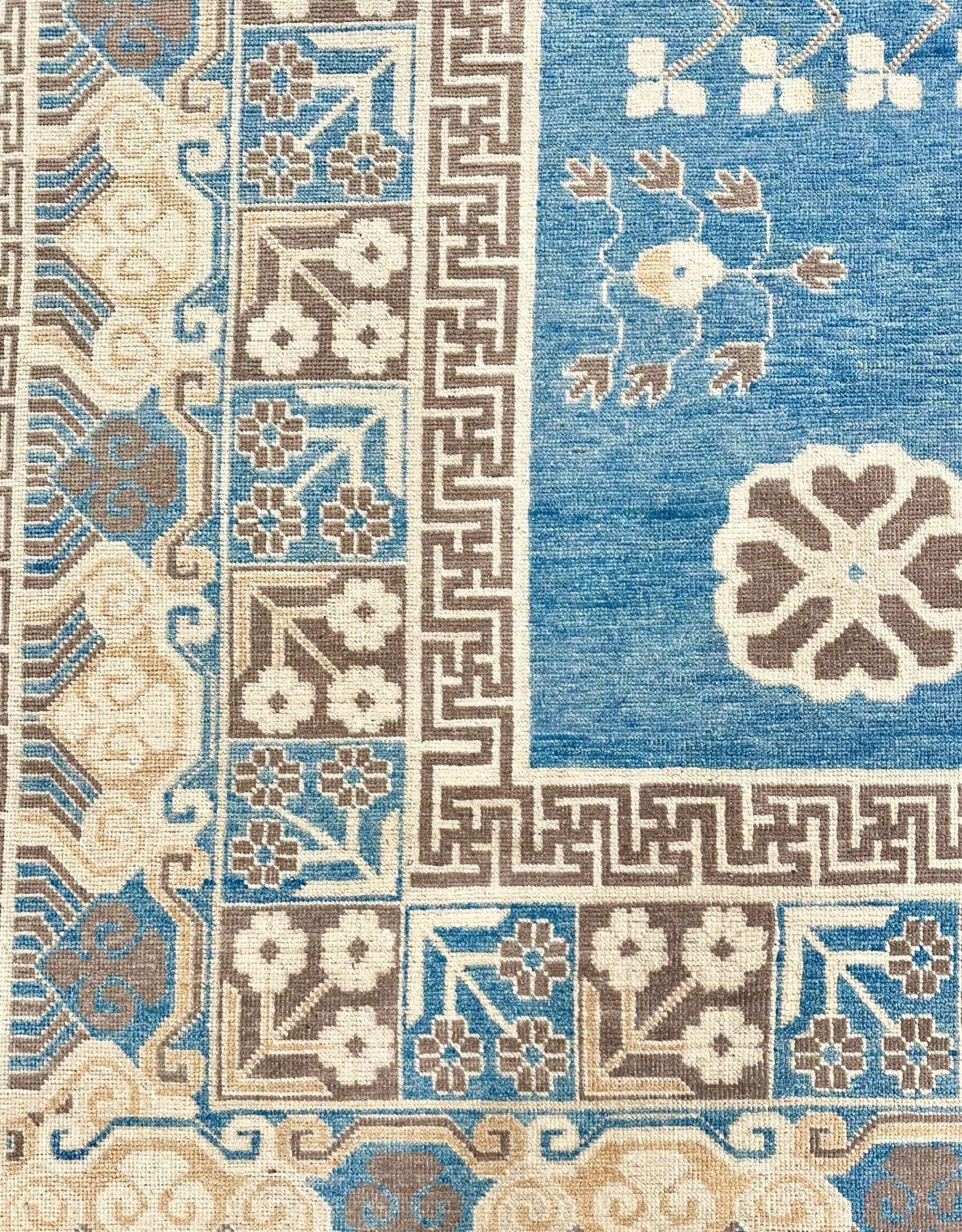 Stunning luxury hand-knotted rug! Reminiscent of a ming vase, with a greek key border band. Blue field with accent colors of brown, cream, and cafe au lait. Large rug measuring 12' x15'6". 