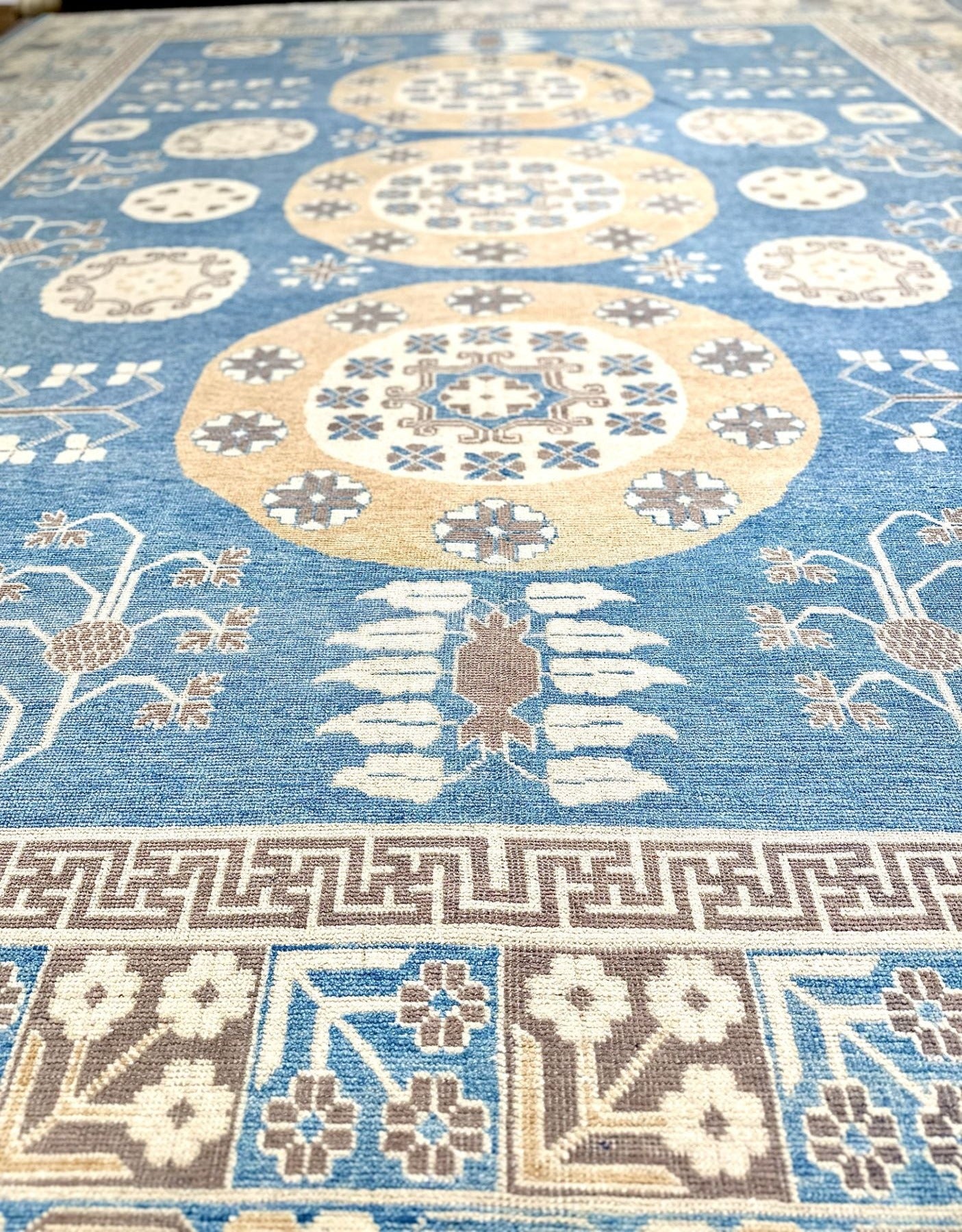 Stunning luxury hand-knotted rug! Reminiscent of a ming vase, with a greek key border band. Blue field with accent colors of brown, cream, and cafe au lait. Large rug measuring 12' x15'6".