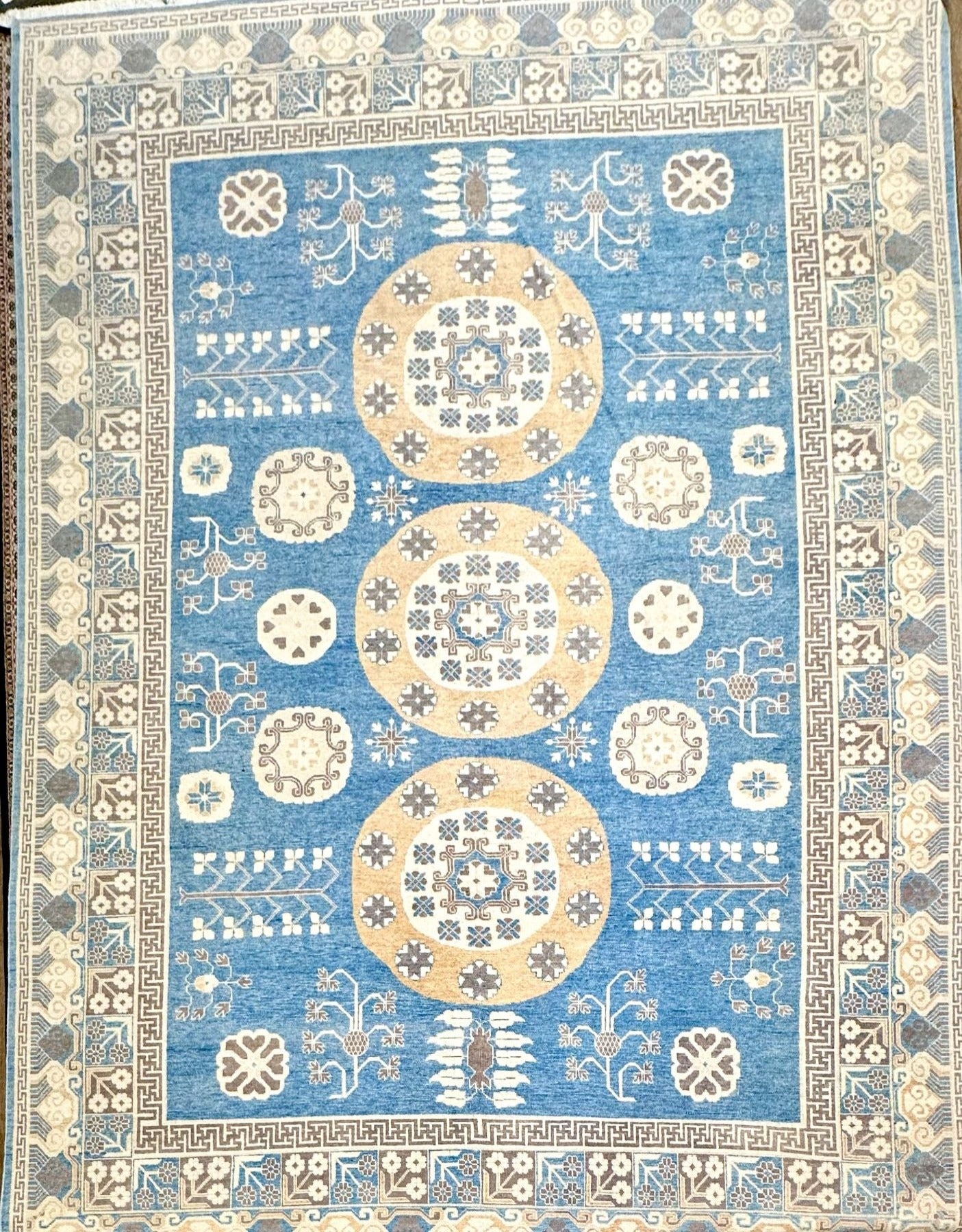 Stunning luxury hand-knotted rug! Reminiscent of a ming vase, with a greek key border band. Blue field with accent colors of brown, cream, and cafe au lait. Large rug measuring 12' x15'6".