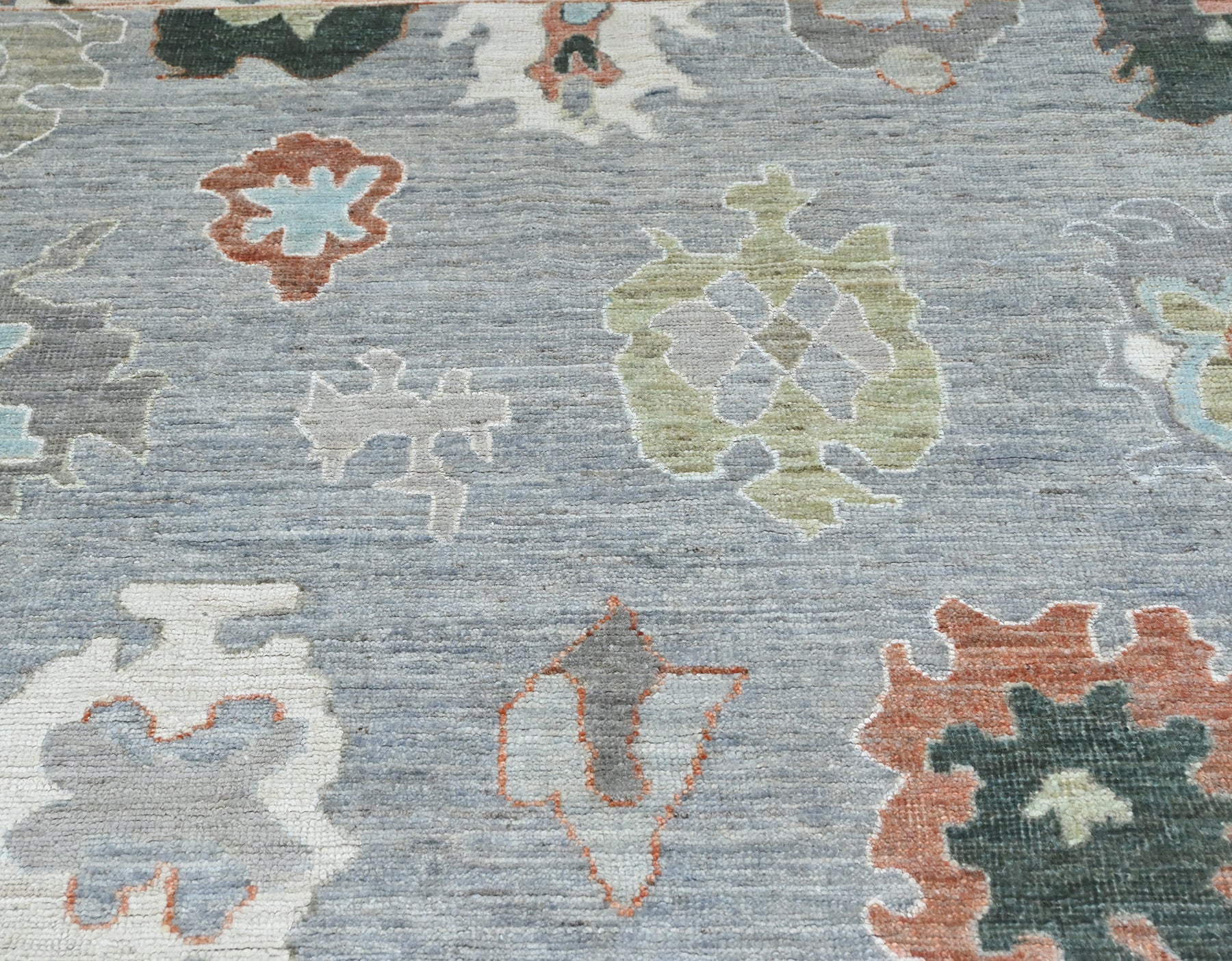 Designer oushak with a blue center and light gray border, size 6 x 9 handknotted rug.