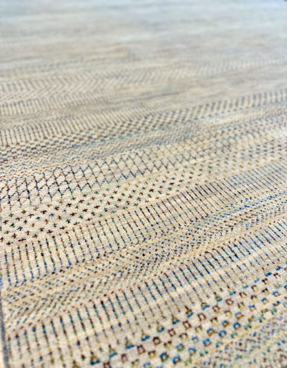 Neutral background wool hand knotted rug with jewel tone accents in a casual, modern palette.