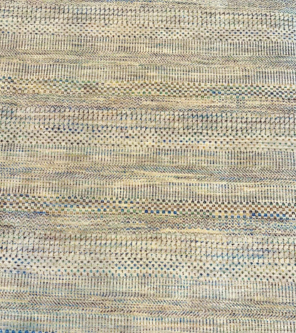Neutral background wool hand knotted rug with jewel tone accents in a casual, modern palette.