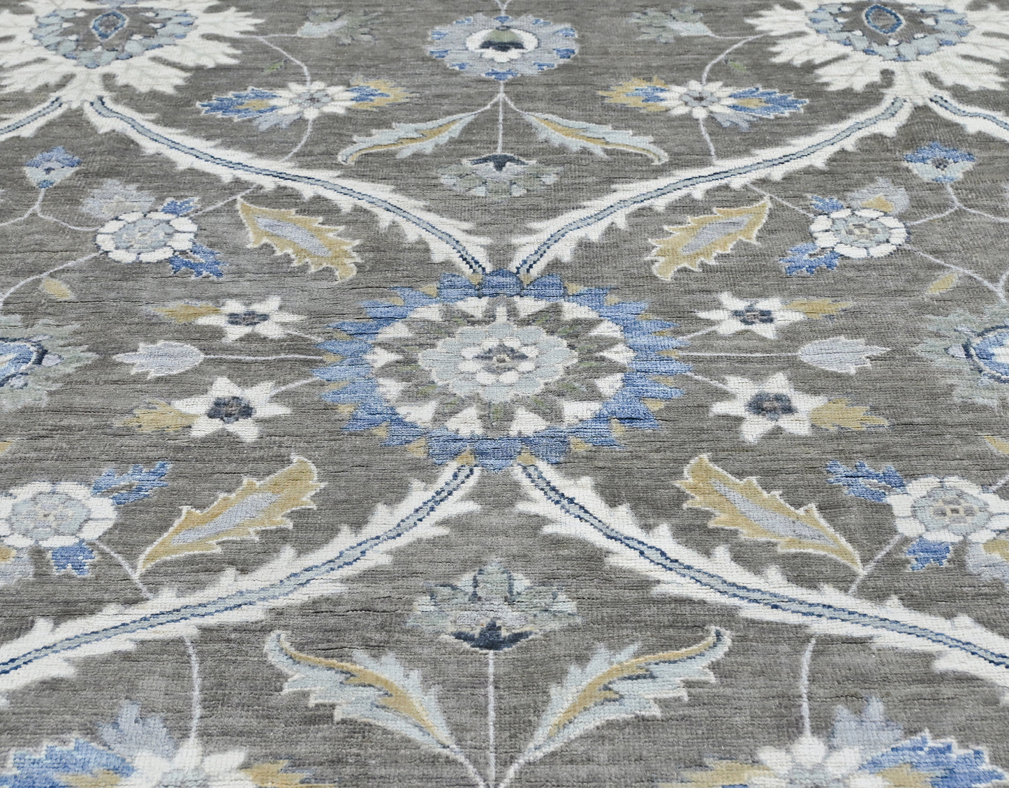 New traditional wool hand-knotted 8 x 10 rug in gray, blue, cream, tan, and brown.