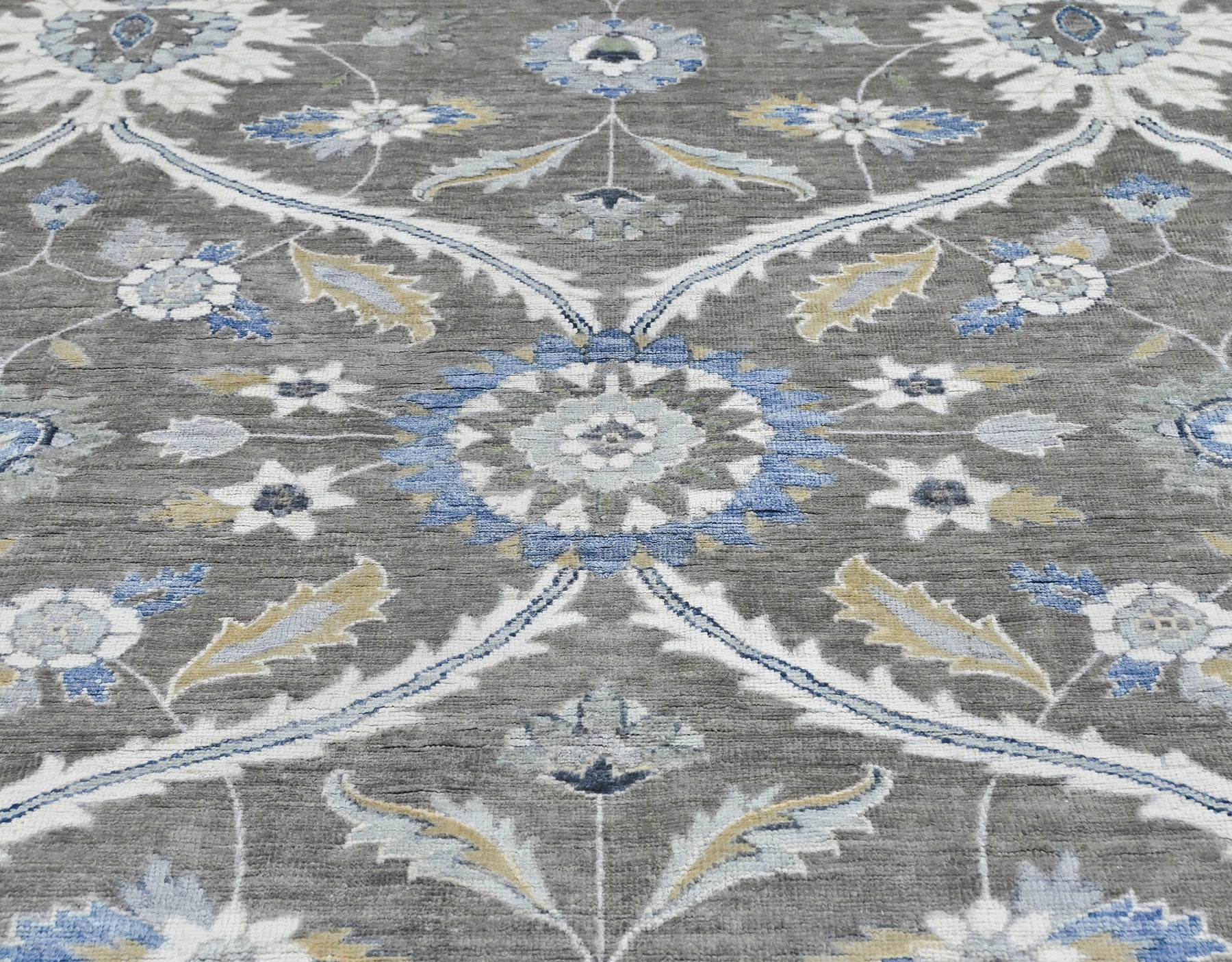 New traditional wool hand-knotted 8 x 10 rug in gray, blue, cream, tan, and brown.