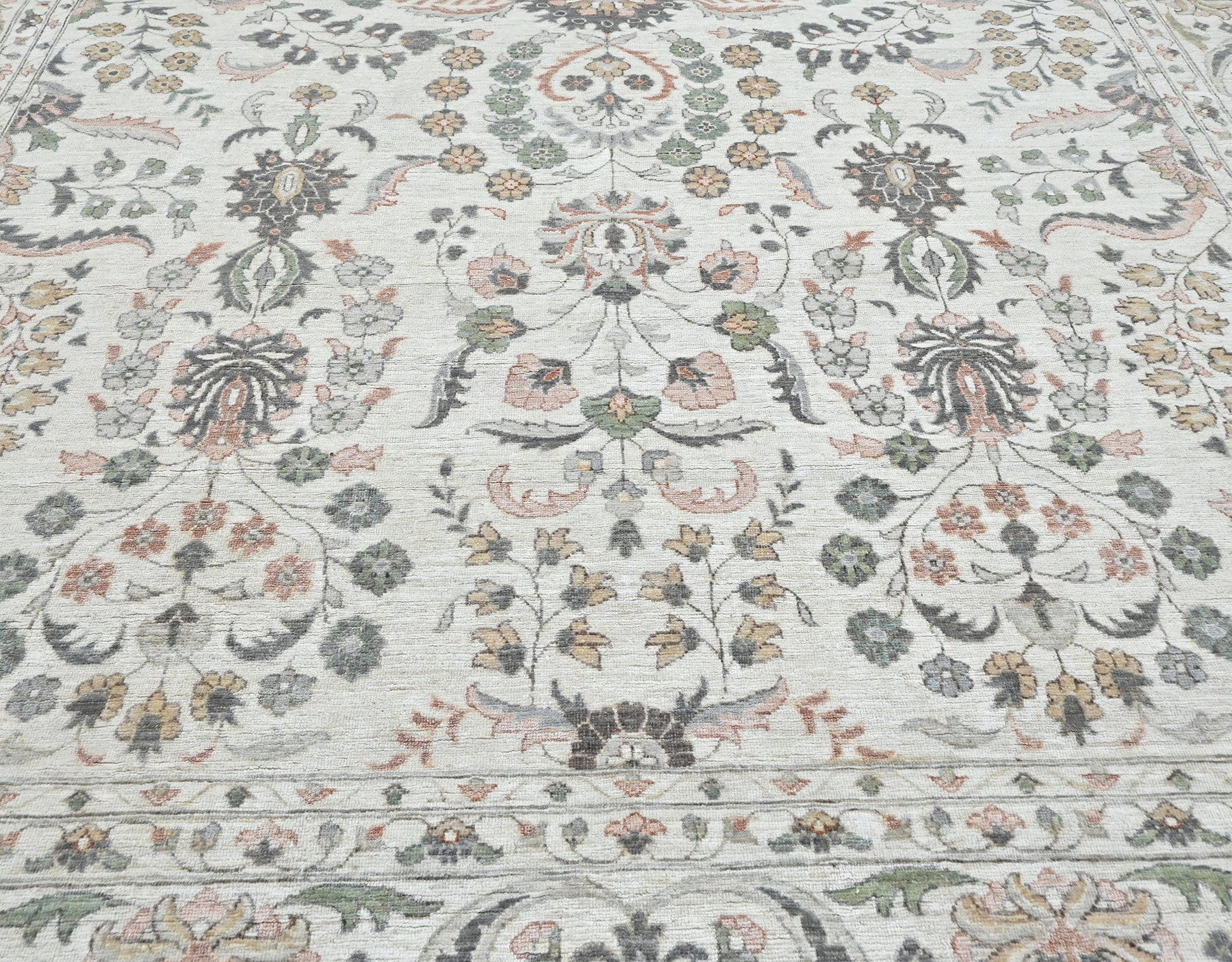 Luxury designer handknotted wool rug, light colors with accents of cinnamon, rust, green, and gray. 10 x 14 size.